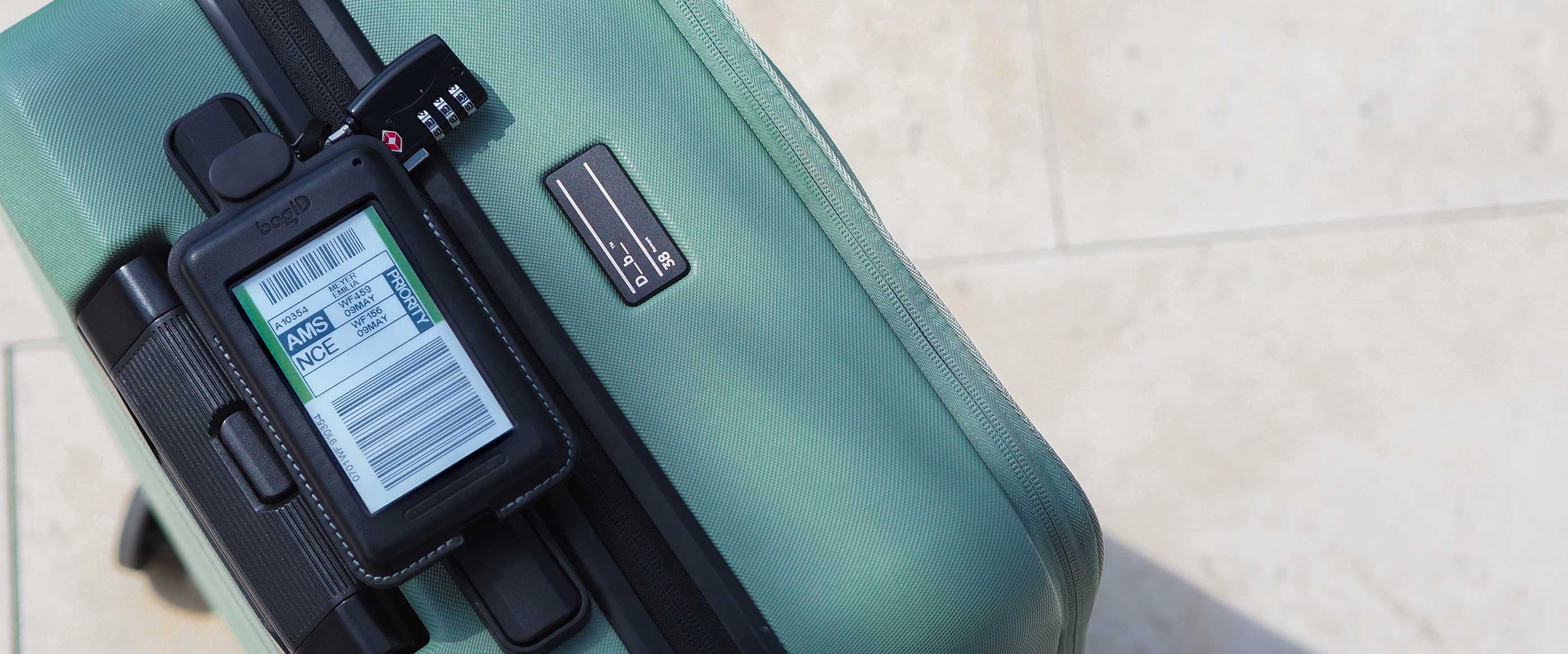 Green suitcase with a digital display on a tiled floor