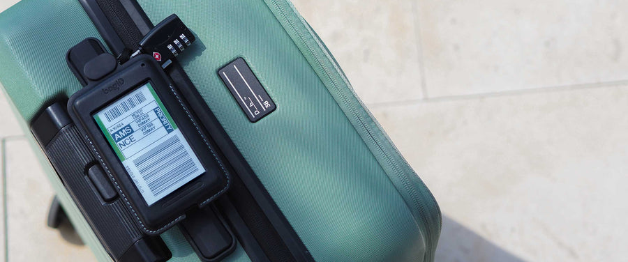 Green suitcase with a digital display on a tiled floor